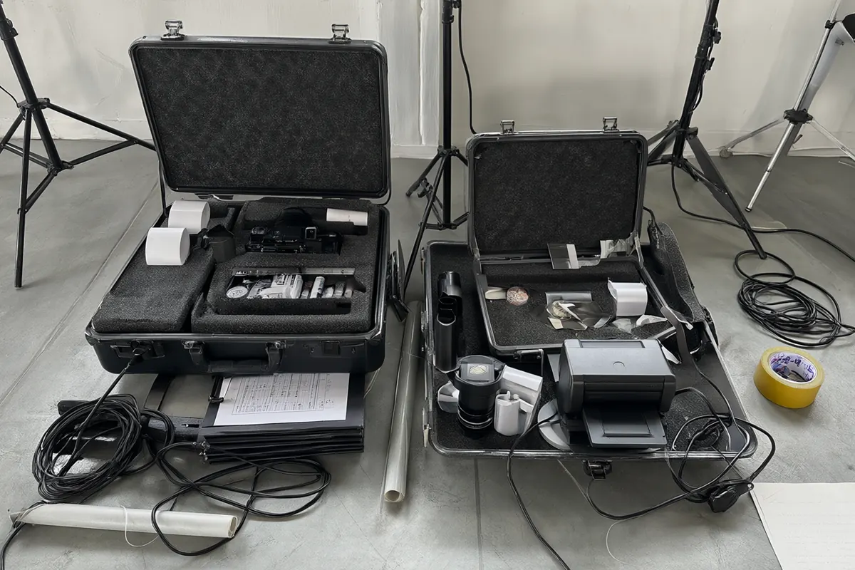 Peralatan photobooth dikemas rapi di dalam hard case, lengkap dengan kabel, kertas, dan stand lampu