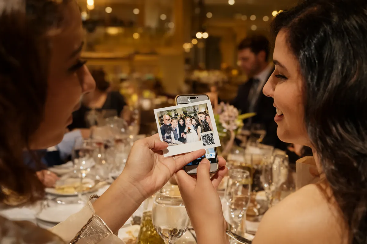 A guest scans the QR code on a printed photo with a smartphone to download it
